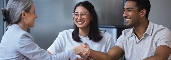 Smile, couple and handshake with financial consultant for deal, agreement or contract. Happy, man and woman shaking hands of broker for finance, loan or mortgage, welcome and thank you for investment.